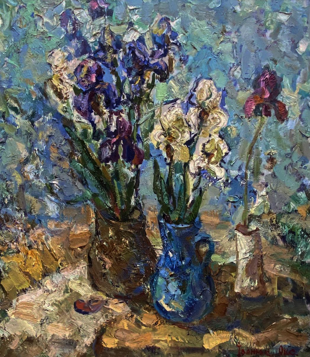 Vibrant blue ceramic vase with handle holding white purple irises by Oksana Ivanyuk