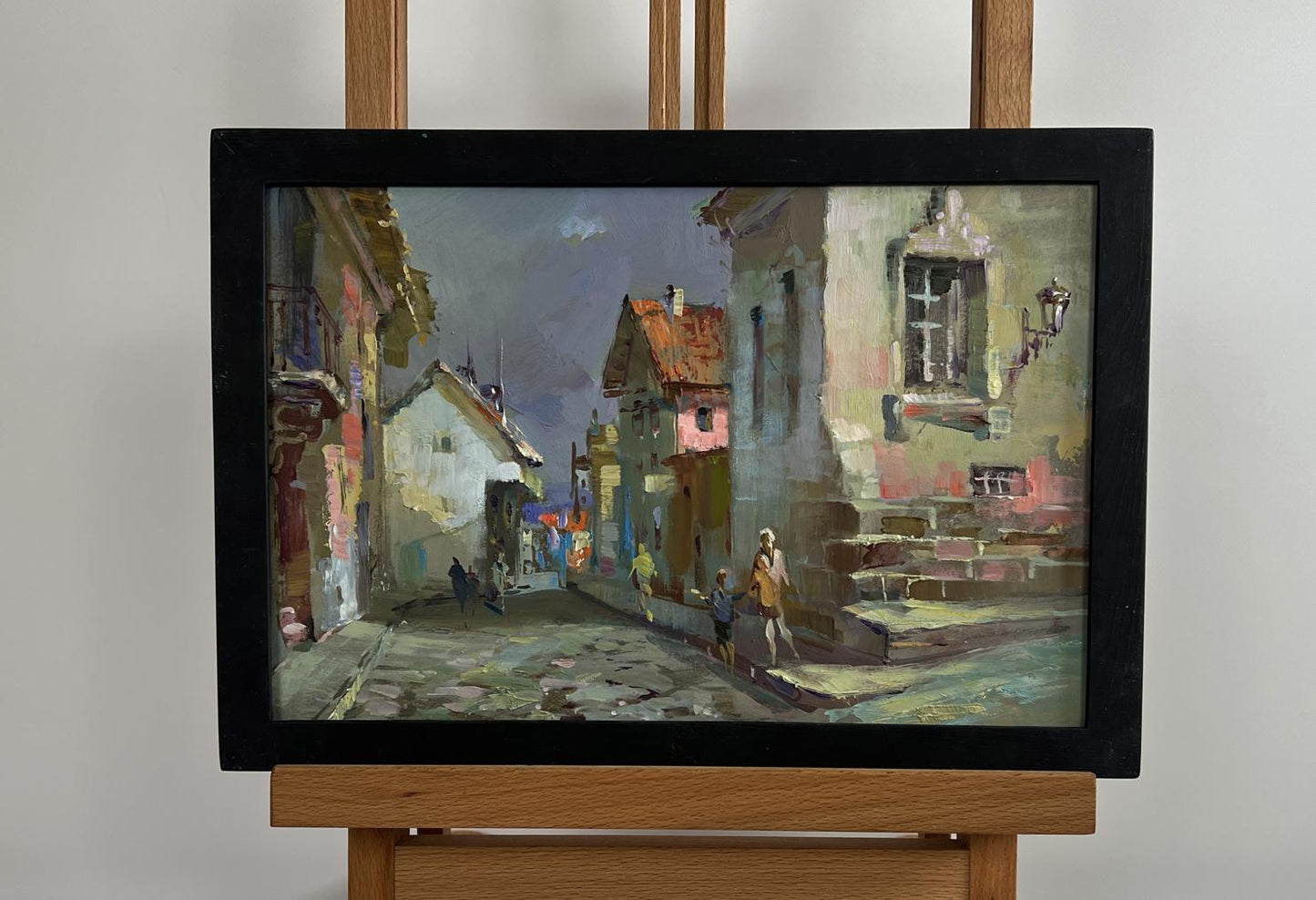 Oil painting Walking along the city street by Yuriy Suprunchuk in black frame