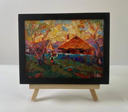Vibrant oil painting of sunset village glow by Oleksiy Ivanyuk in black frame