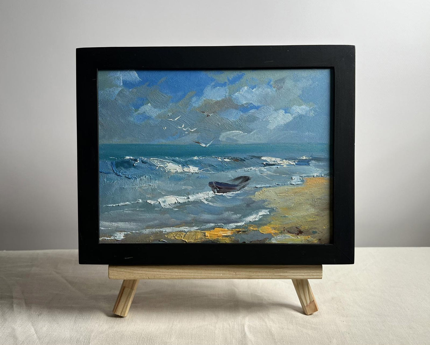 Framed oil painting of seagulls on seashore by Yuriy Suprunchuk