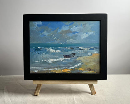 Framed oil painting of seagulls on seashore by Yuriy Suprunchuk