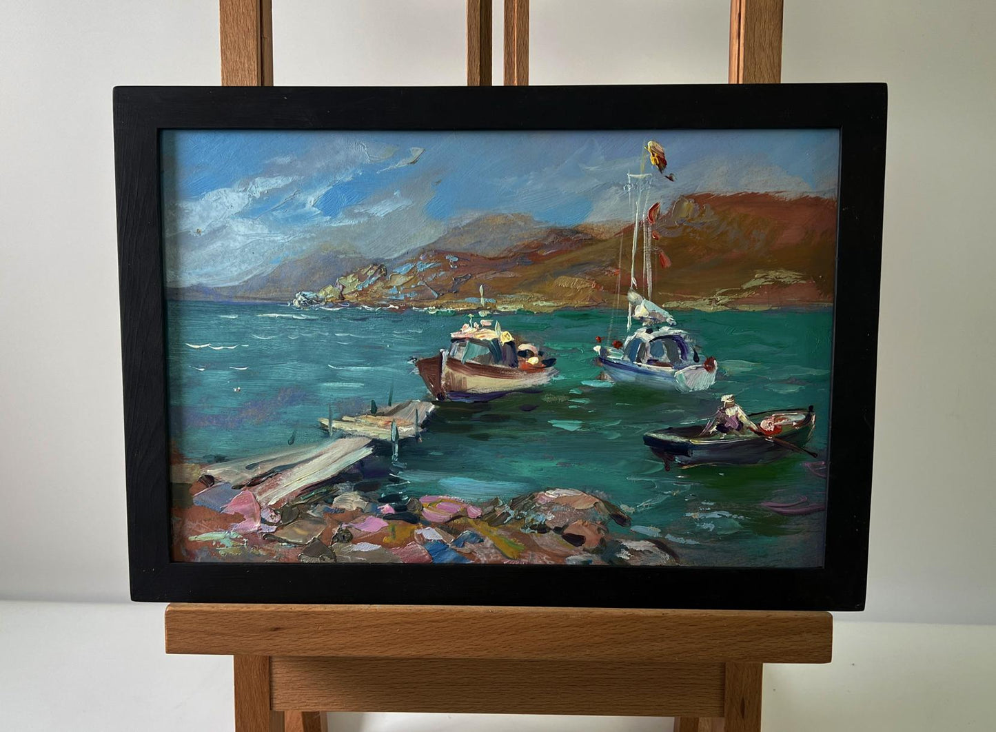 Oil painting of boats on seashore by Yuriy Suprunchuk in black frame