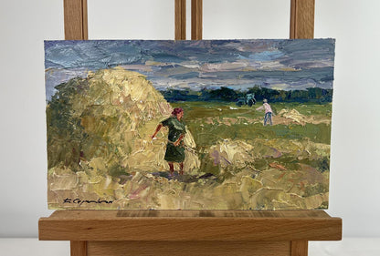 Oil painting by Boris Serdyuk: figures working in field under blue sky