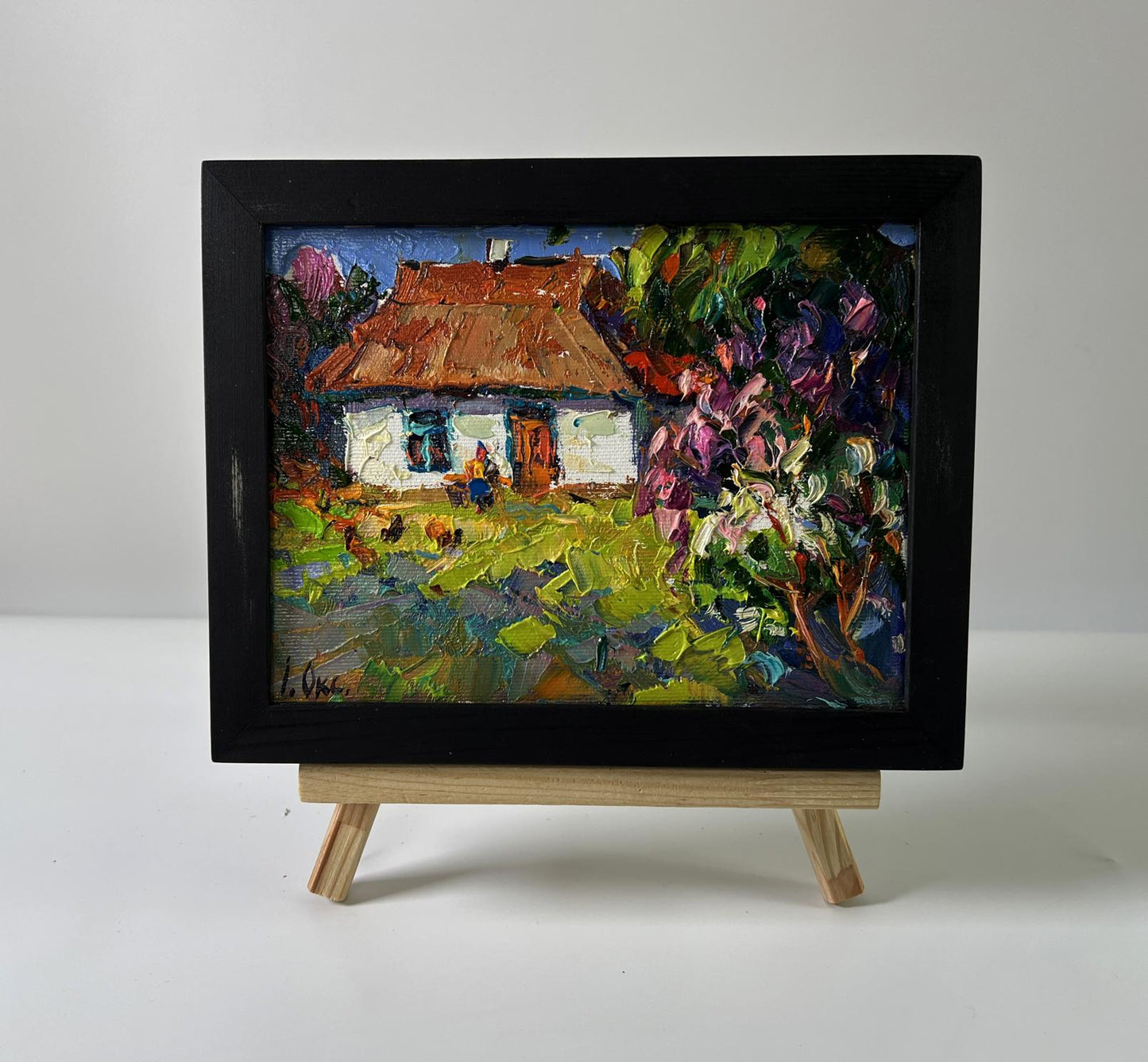 Vibrant oil painting of flowering bush in garden by Oksana Ivanyuk in black frame
