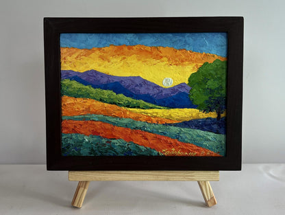 Oil painting of blue mountains with yellow sunset by V. Zadorozhnya in black frame