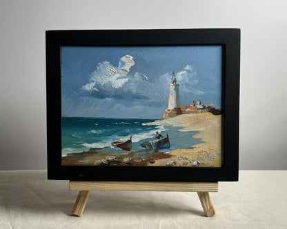 Framed oil painting by Yuriy Suprunchuk: boats at lighthouse coastal scene