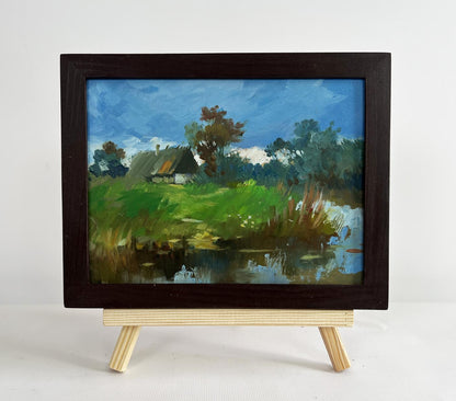 Oil painting A lonely house by the river by Yuriy Suprunchuk in dark frame