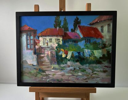 Oil painting of village life by Yuriy Suprunchuk with red roofs