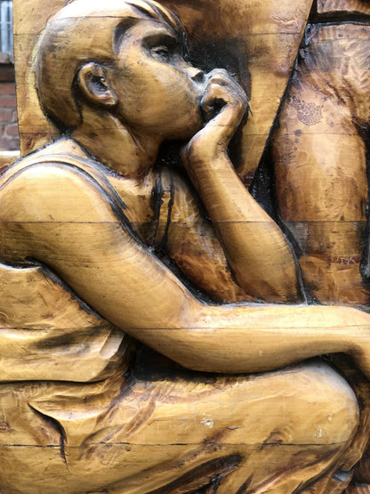 Detailed wooden carving of contemplative boy in Social realism Communist Labor Brigade