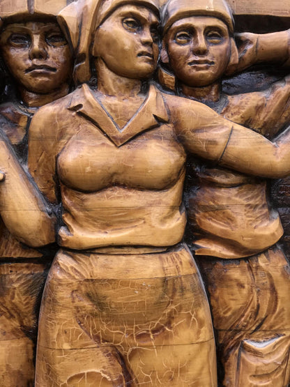 Bronze wooden relief of women in Communist Labor Brigade uniforms