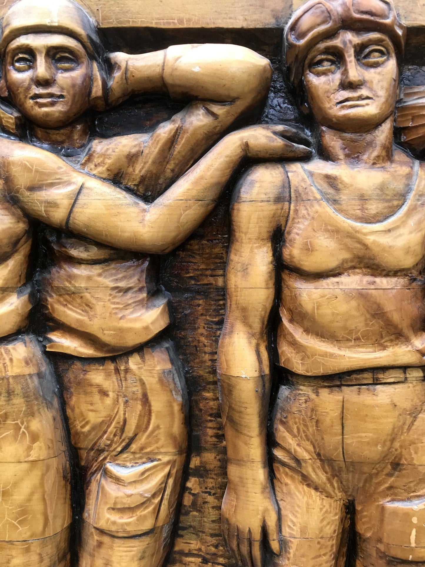 Carved wooden relief of two women in vintage aviator attire, Social realism Communist Labor Brigade