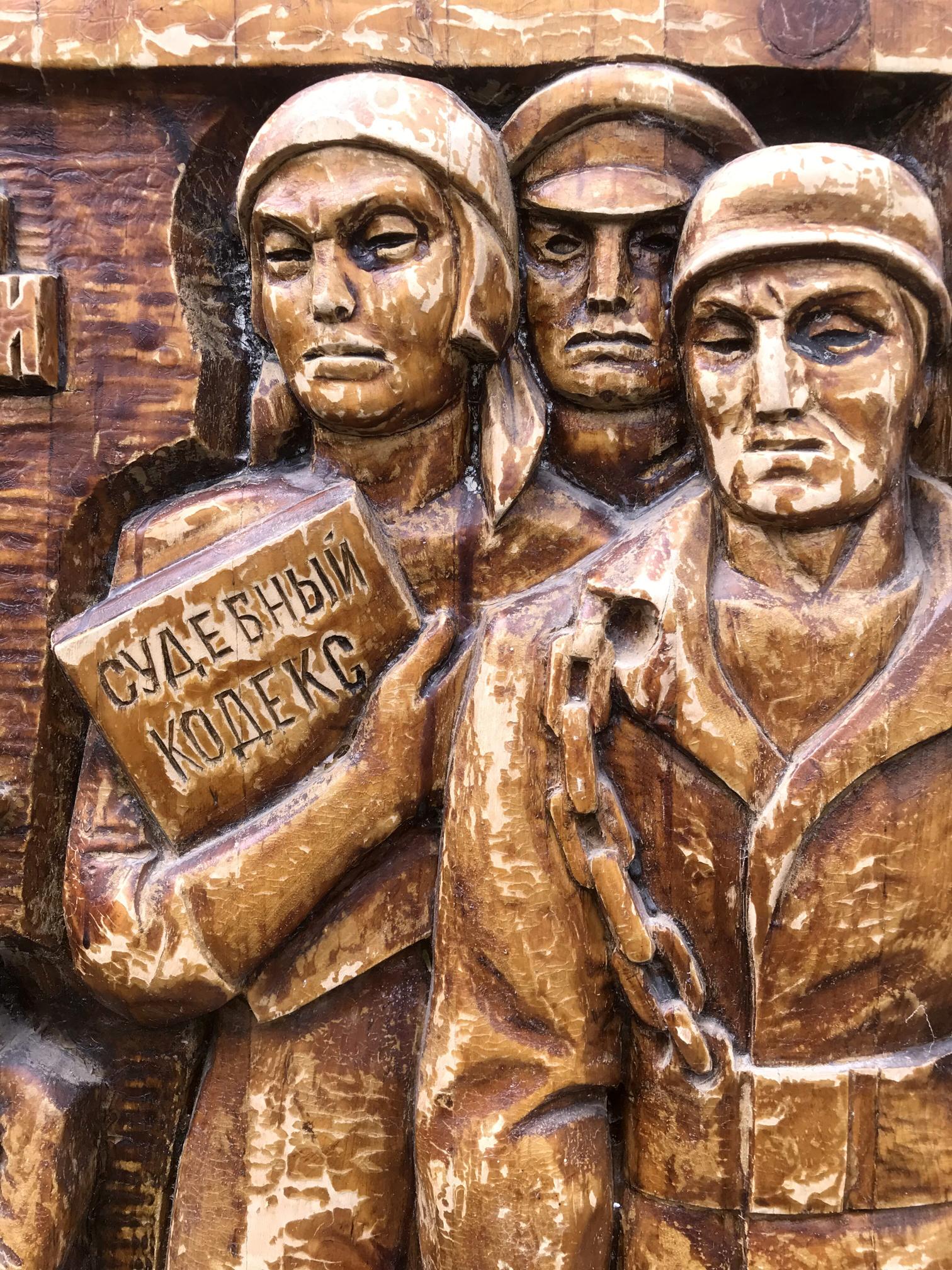 Bronze wooden relief of military figures with Cyrillic book, social realism art