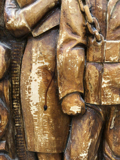 Weathered golden-brown wooden carving of intransigent social realist figure