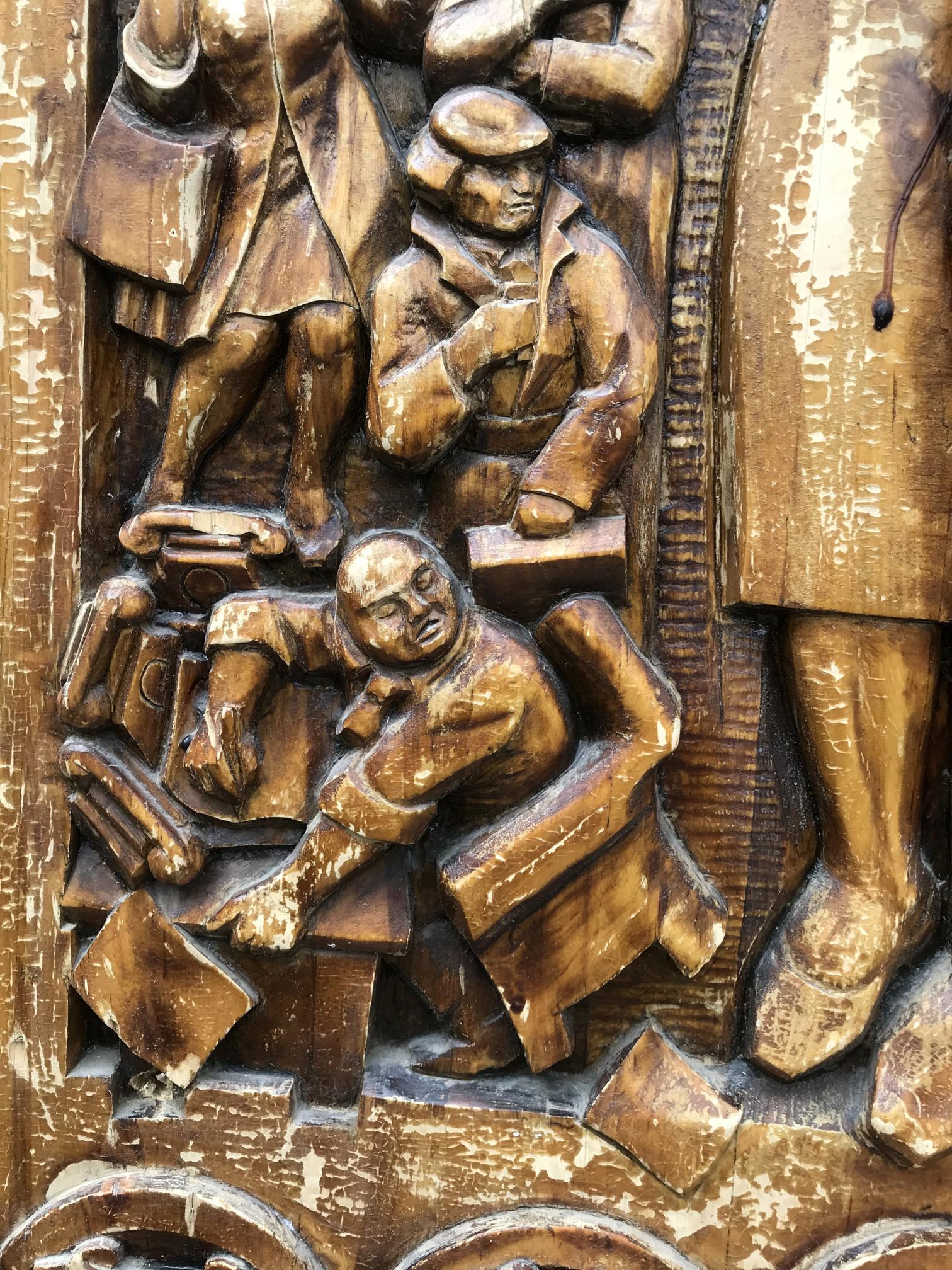 Carved wooden relief of social realism workers, weathered brown finish