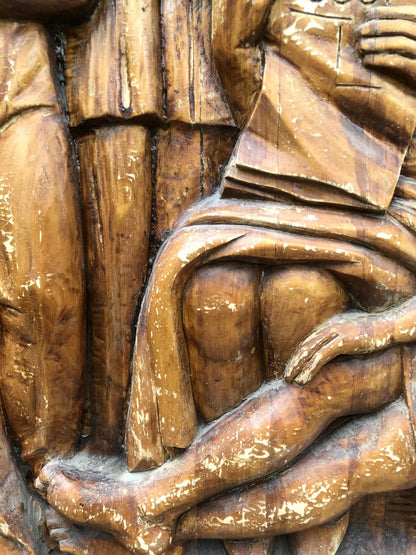 Social realism wooden carving of honest figures in warm textured wood