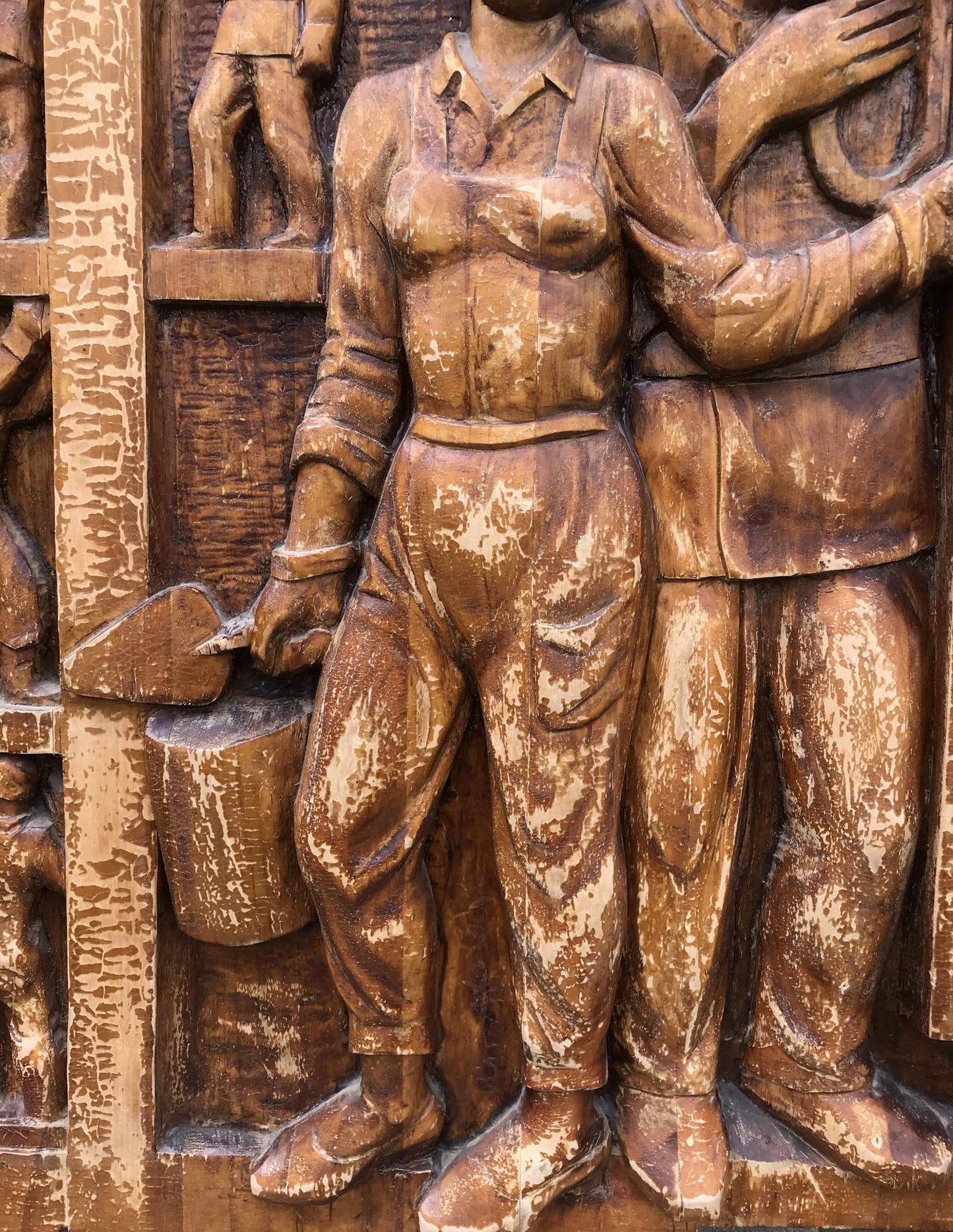 Bronze wooden relief of woman in work attire, social realism sculpture