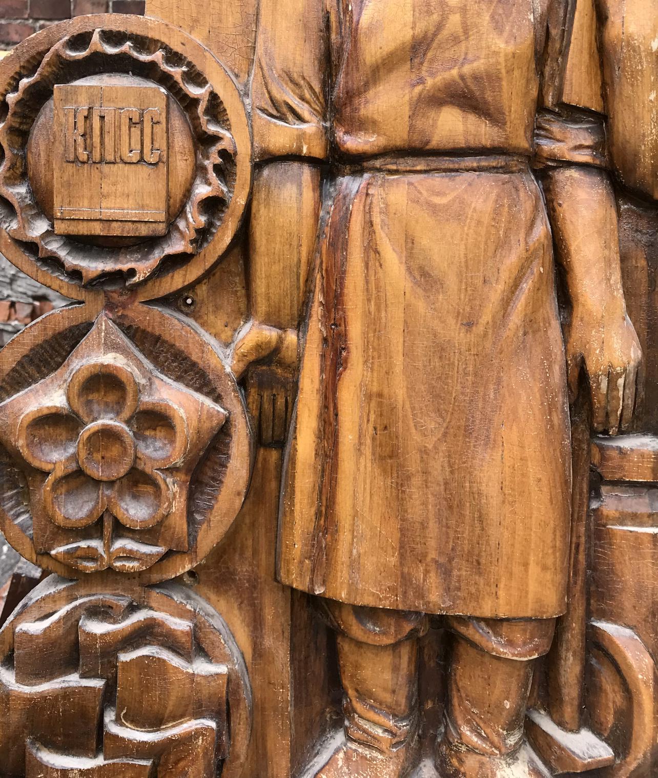 Social realism wooden relief of king in traditional attire with motifs