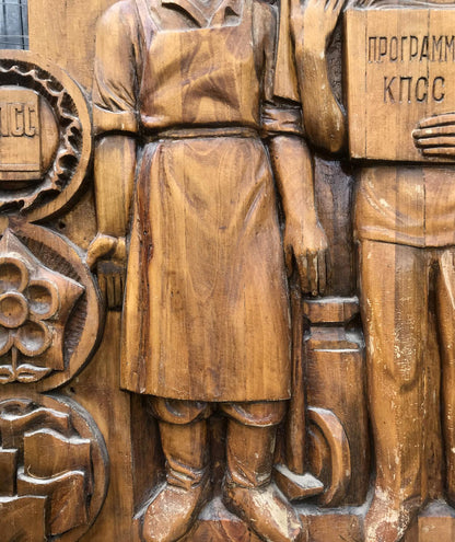 Detailed wooden carving of social realism communist devotion figure in apron and boots