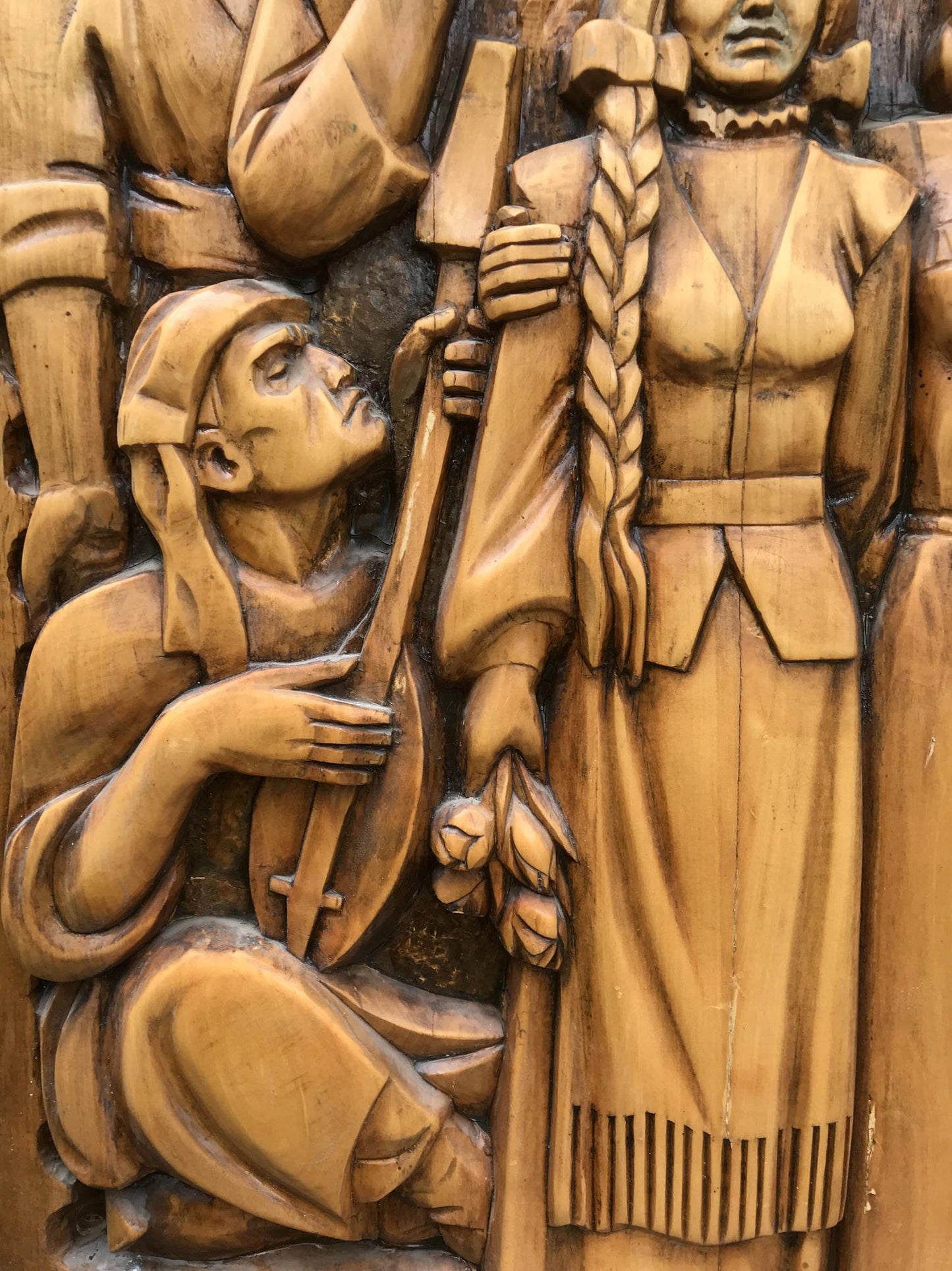 Carved wooden relief of kneeling lute musician and woman, USSR brotherhood art