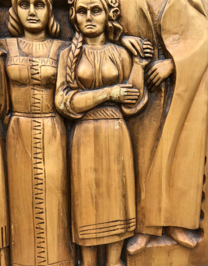 Carved wooden relief of USSR peoples friendship: two women in traditional attire