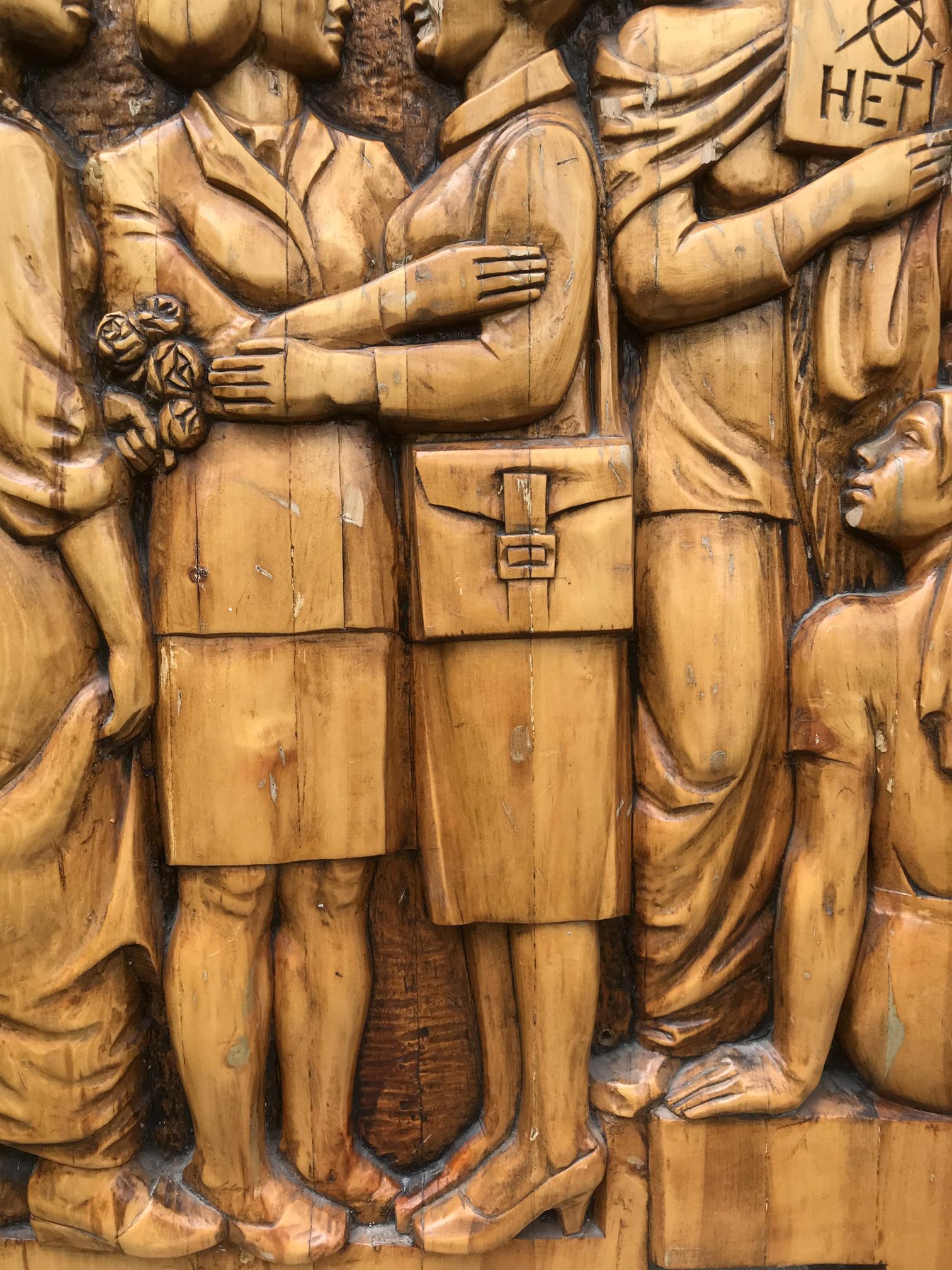 Social realism wooden relief sculpture of fraternal solidarity with working people