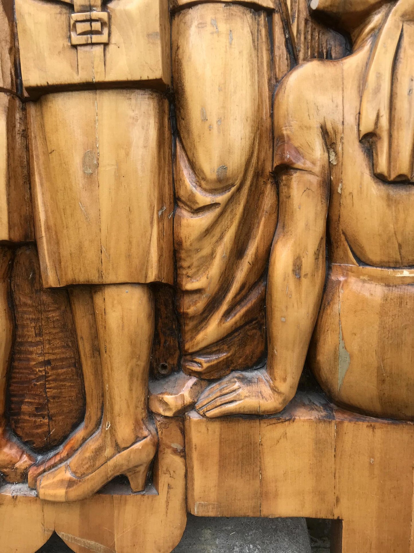 Detailed wooden carving of legs in high heels, social realism fraternal solidarity