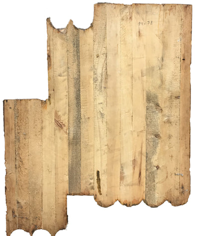Weathered light brown wooden panel with scalloped edges and grain patterns