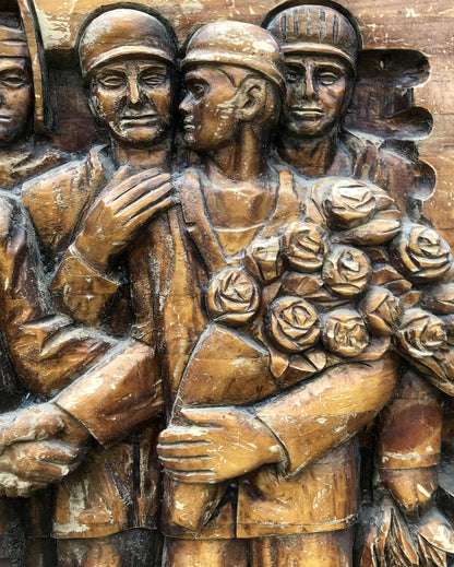 Detailed wooden relief of three soldiers with roses, social realism art