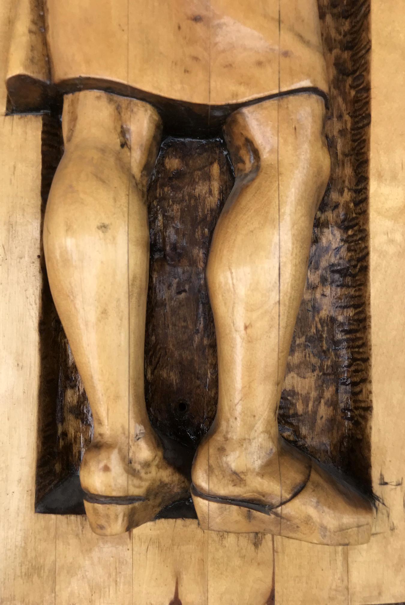 Carved wooden legs in traditional footwear with natural grain, Social realism Law on Nature Protection sculpture