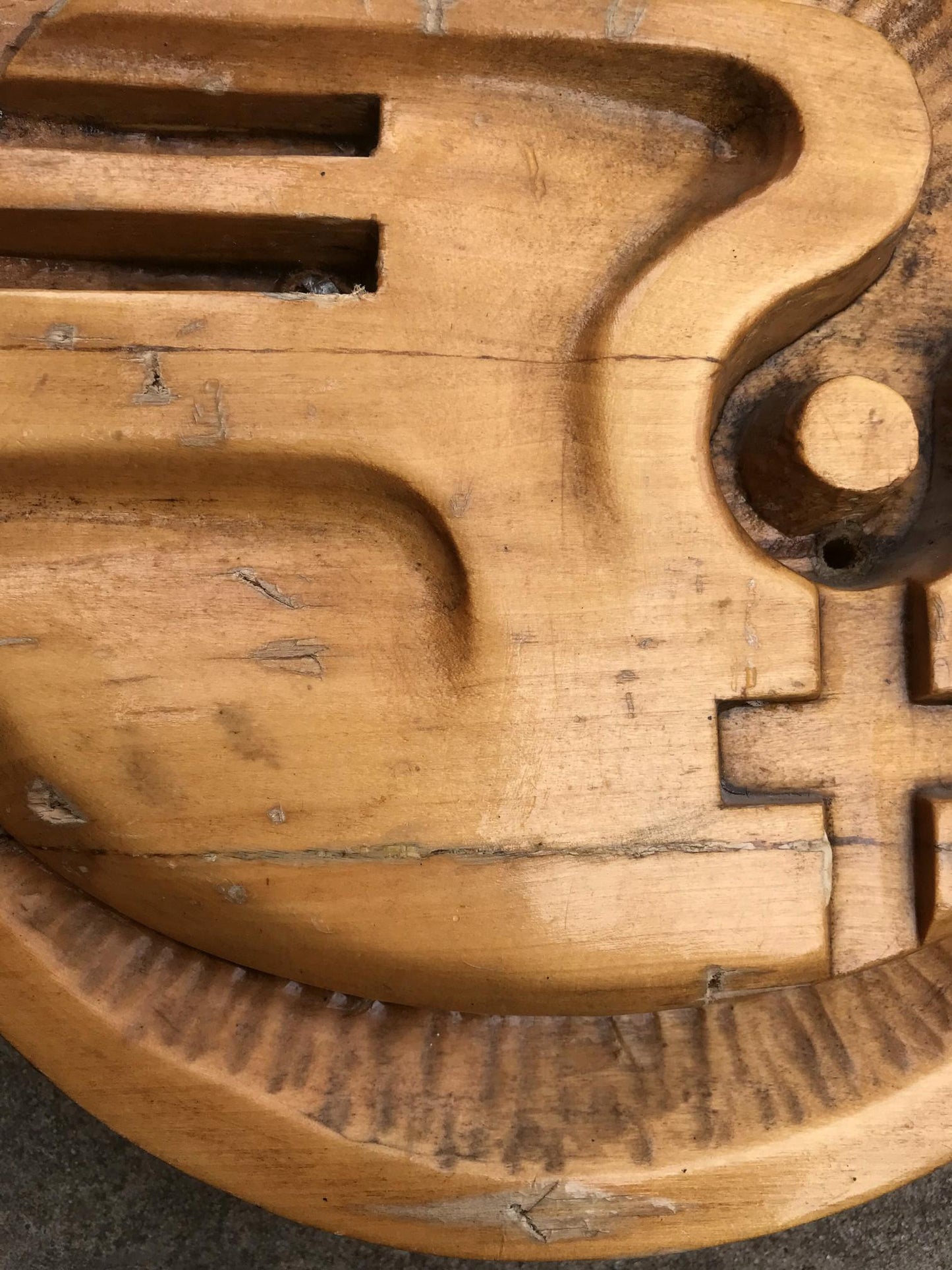 Weathered light brown wooden puzzle piece with grooves and hole, Social realism Dove of peace
