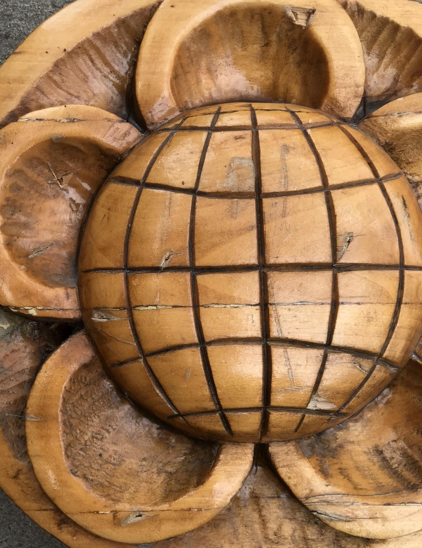 Hand-carved lotus flower wooden bowl with central globe design