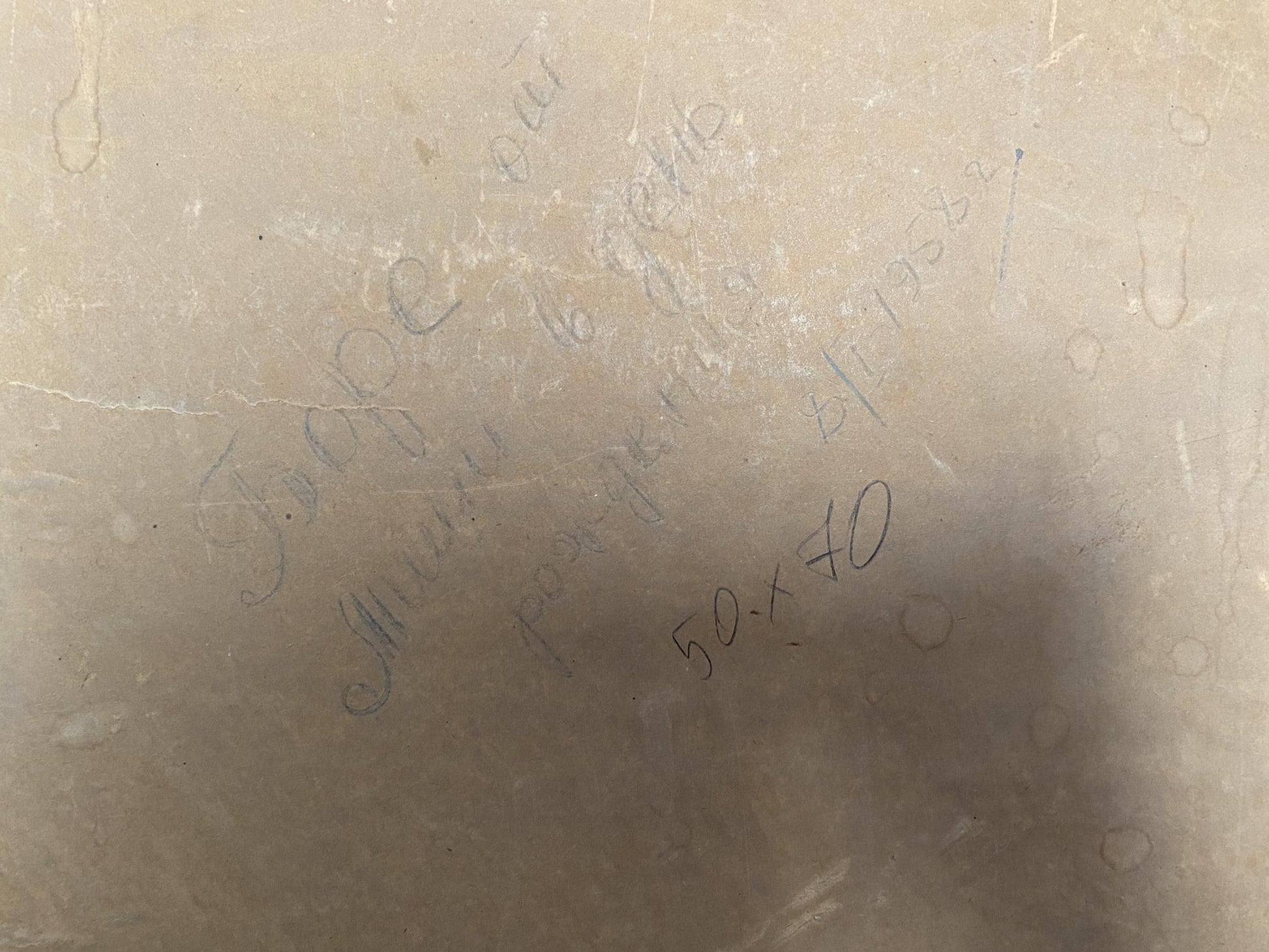 Back of beige marble slab with faint engraved Oil painting Rocky coast Strelov Arkady Efimovich text and circular patterns