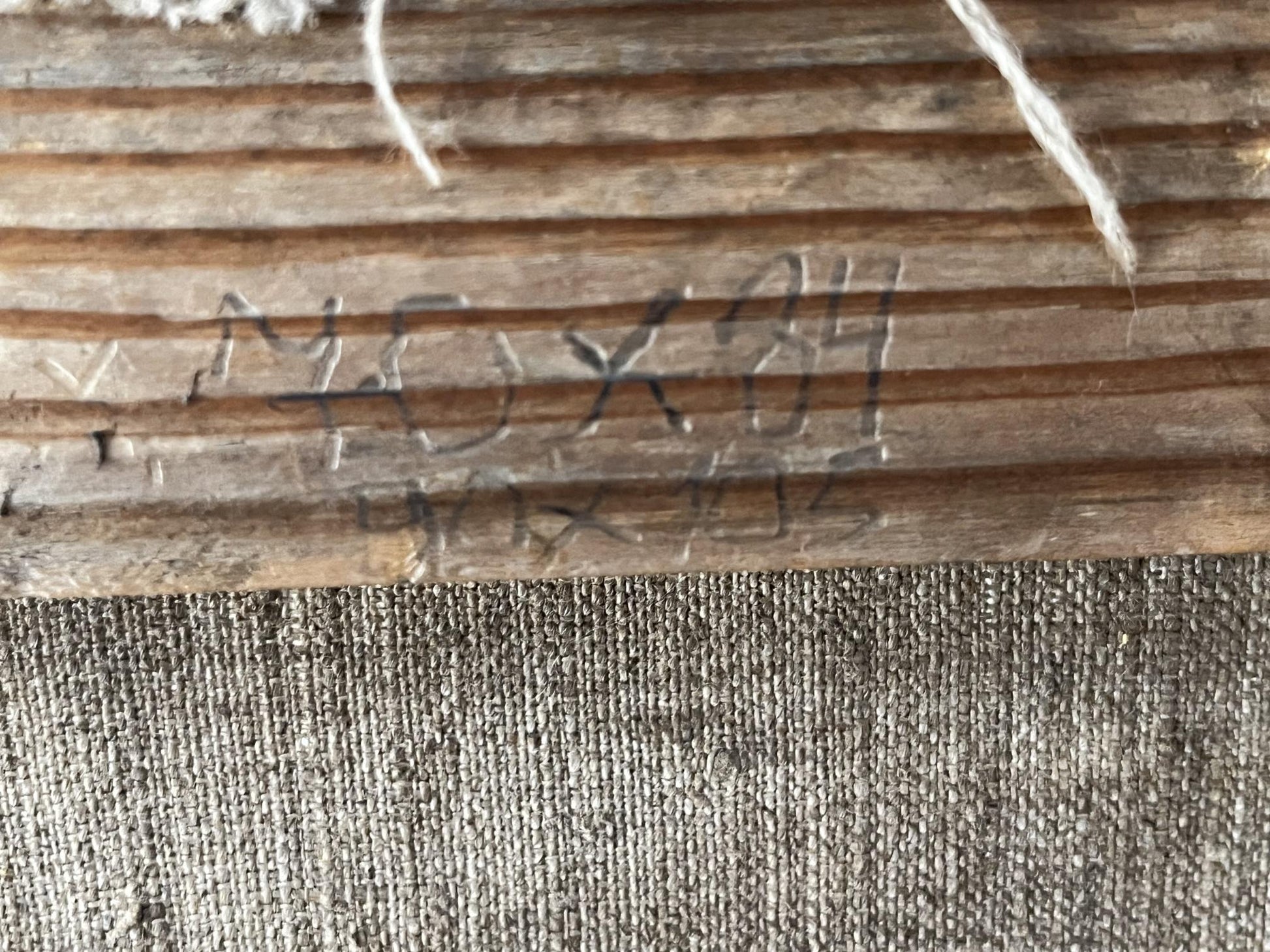 Back of Oil painting Odessa is a delightful city: weathered plank with measurements, frayed string