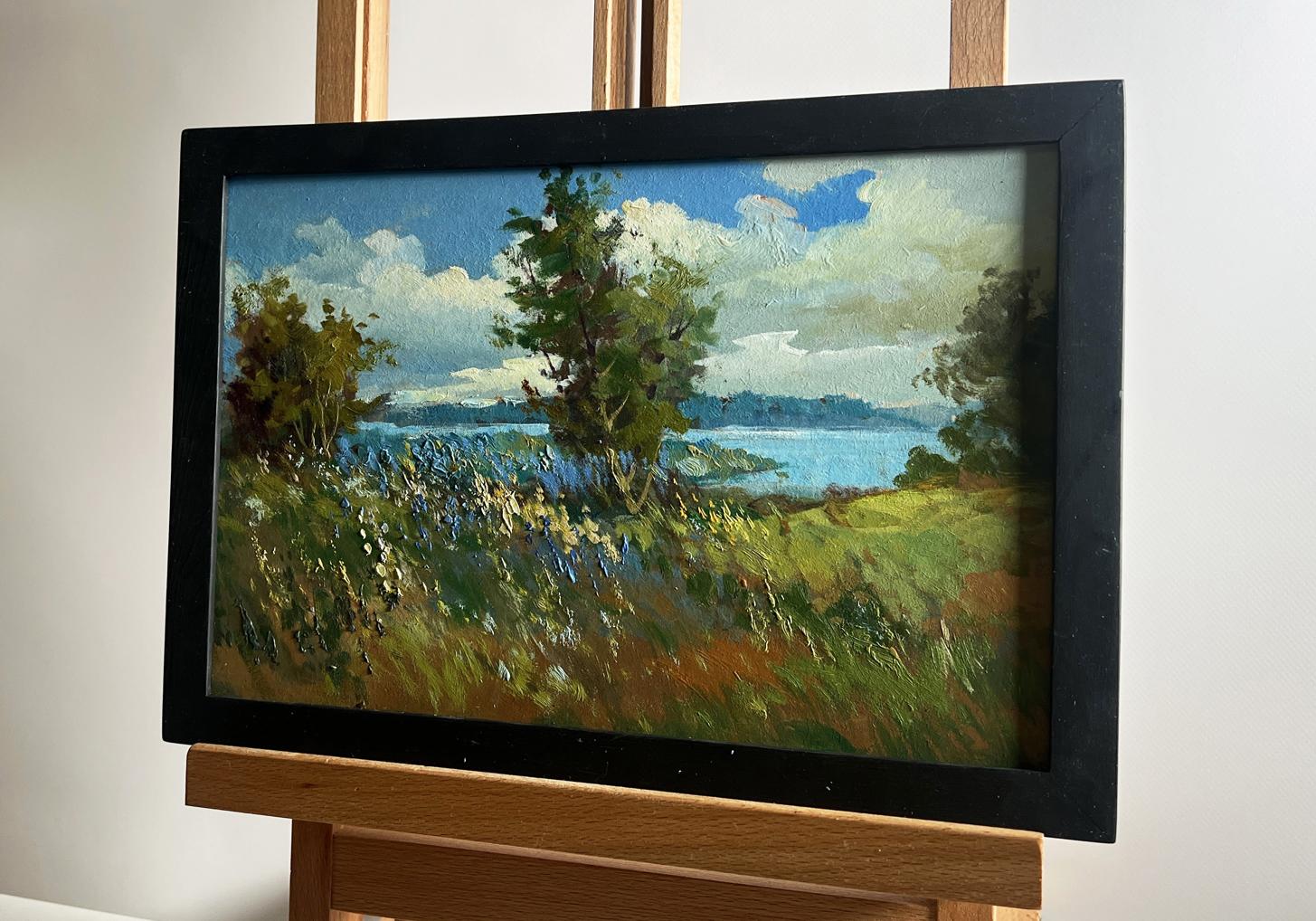Oil painting of flower field and river by Yuriy Suprunchuk in black frame