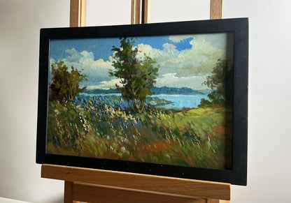 Oil painting of flower field and river by Yuriy Suprunchuk in black frame