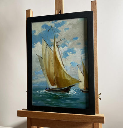 Framed oil painting of sailboats at sea by Yuriy Suprunchuk on wooden easel