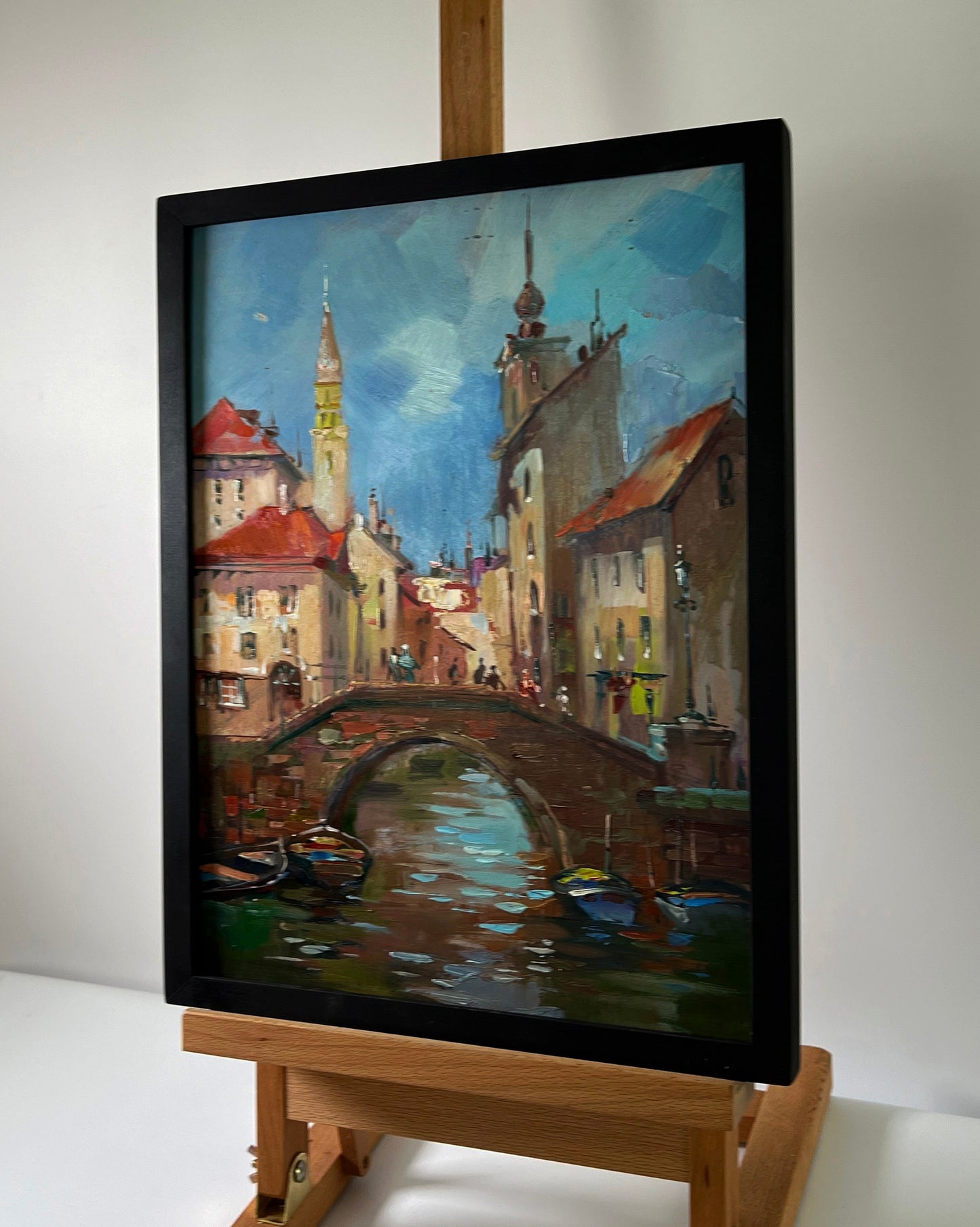 Oil painting of European canal city with river by Yuriy Suprunchuk in black frame