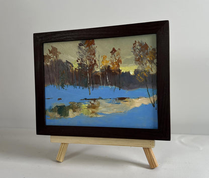 Framed oil painting of winter landscape with yellow sunset reflection by Yuriy Suprunchuk