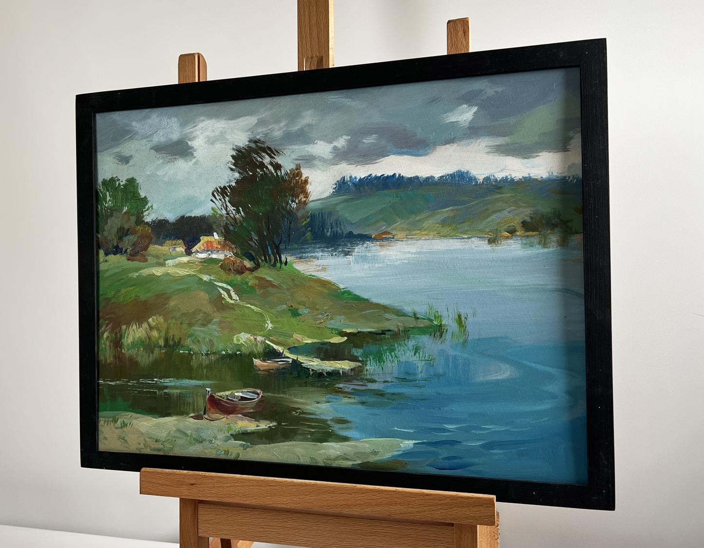 Oil painting of river near village by Yuriy Suprunchuk, serene lakeside scene