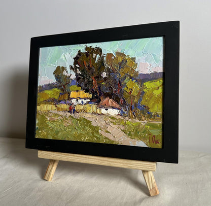 Oil painting Village houses by Oksana Ivanyuk, black-framed rural landscape