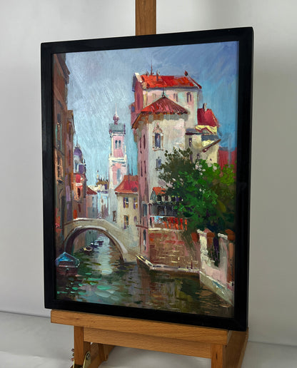 Framed oil painting of European canal by Yuriy Suprunchuk in black frame
