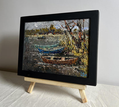 Oil painting Autumn melancholy by Oksana Ivanyuk, boats on shoreline in black frame