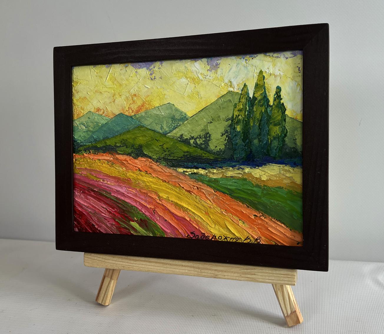 Vibrant oil painting of sunset behind forest mountains by V. Zadorozhnya