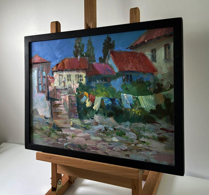 Framed oil painting of village life by Yuriy Suprunchuk