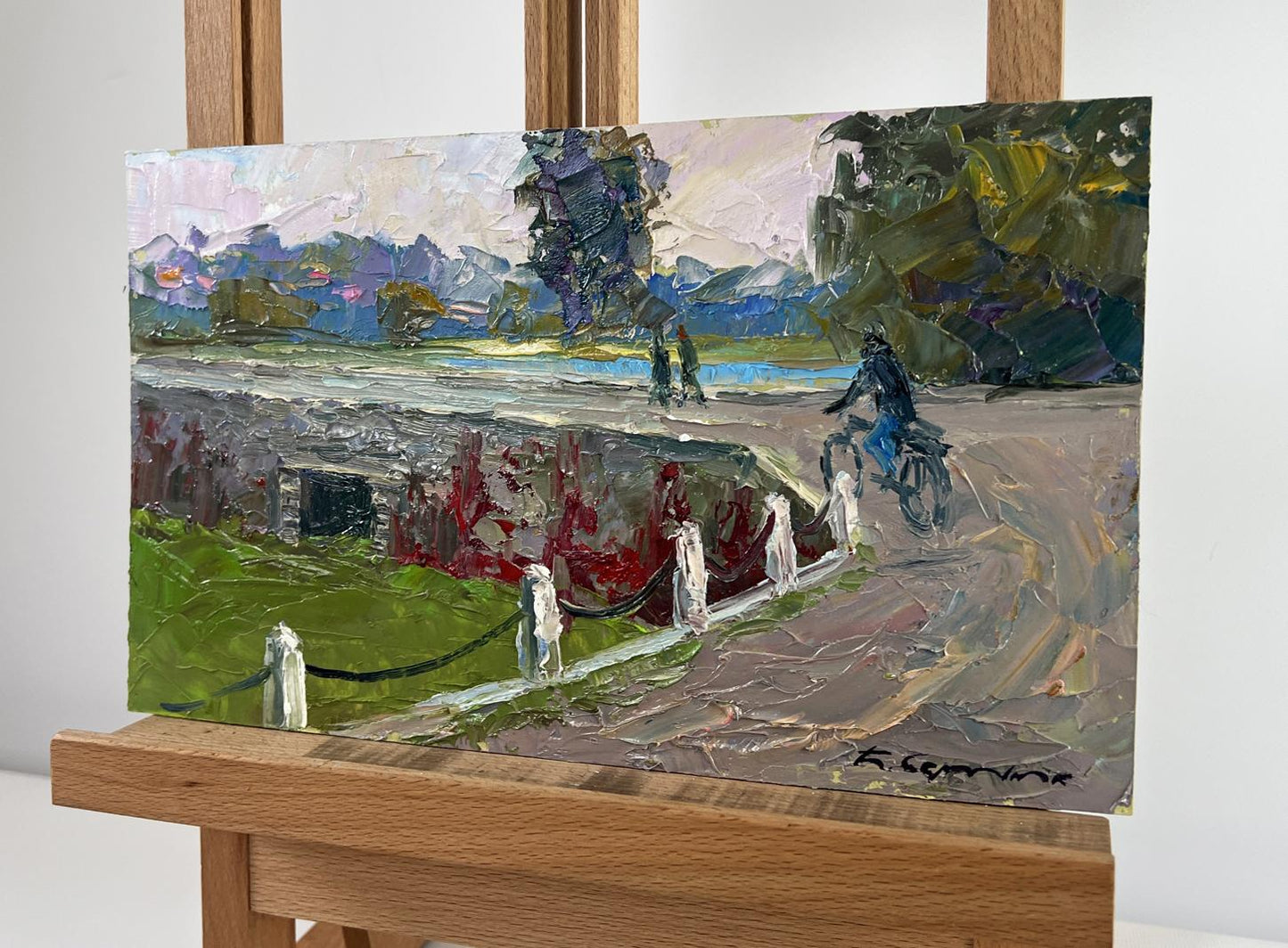 Oil painting of cyclist on mysterious evening dam by Boris Serdyuk