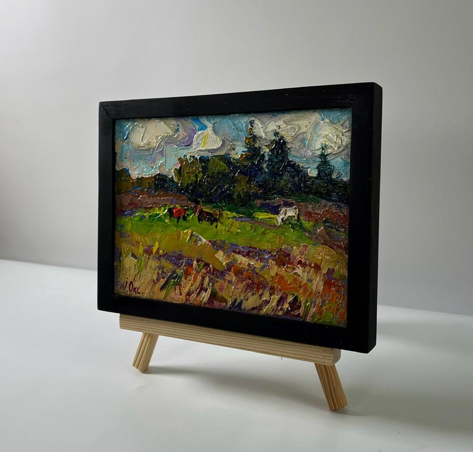 Oil painting Summer nature by Oksana Ivanyuk: cows in vibrant field on easel
