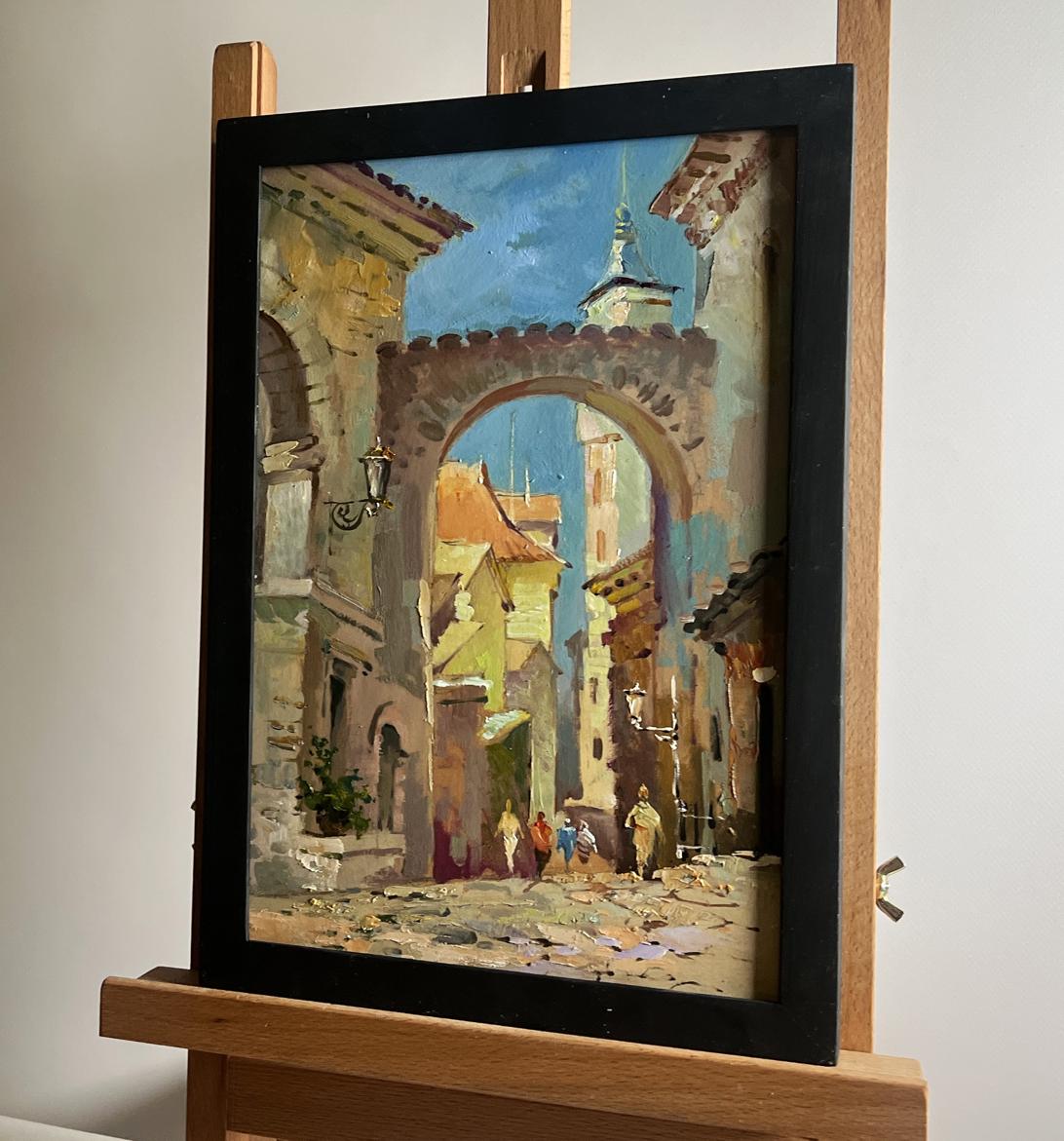 Oil painting Old street of the city by Yuriy Suprunchuk in black frame on easel