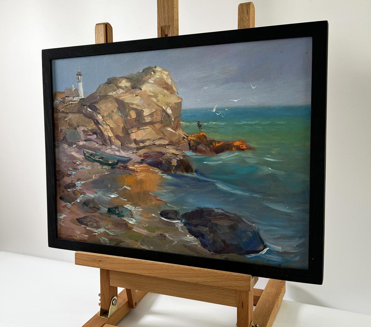 Framed oil painting of seashore with boat by Yuriy Suprunchuk on easel