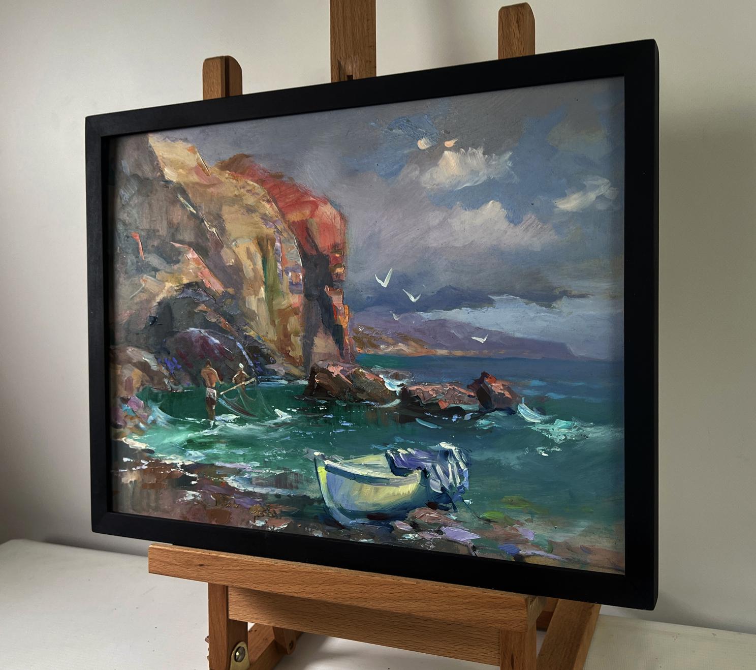 Framed oil painting by Yuriy Suprunchuk of fishermen pulling nets by coastal cliffs