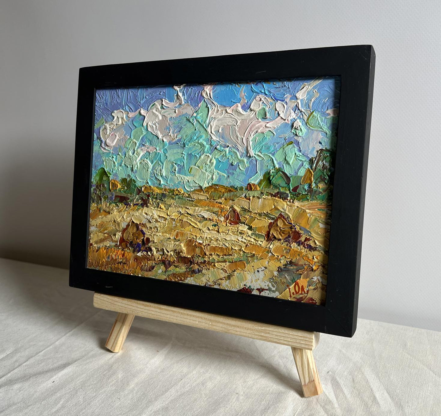Oil painting White clouds over the field by Oleksiy Ivanyuk in black frame